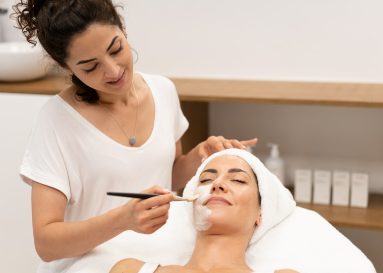 beautician-applying-facial-mask-on-client.jpg
